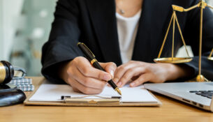 Lawyer Consulting Businessman In Office With Judge Hammer And Justice Scales With Laptop, Attorney Concept And Legal Consulting.