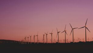 Solar farm in Australia with wind turbines in background – renewable energy insurance risks