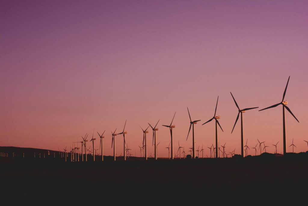 Solar farm in Australia with wind turbines in background – renewable energy insurance risks