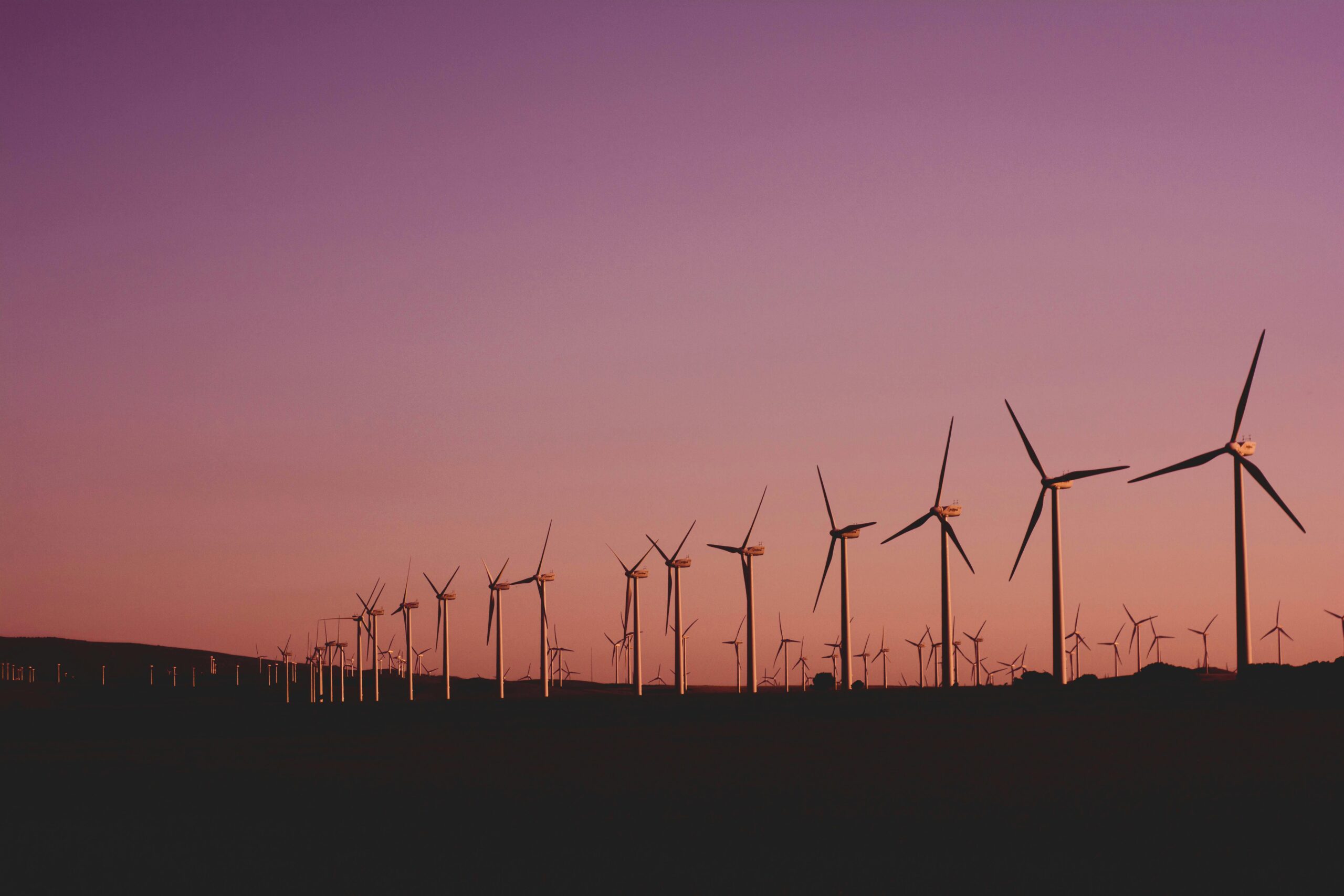 Solar farm in Australia with wind turbines in background – renewable energy insurance risks