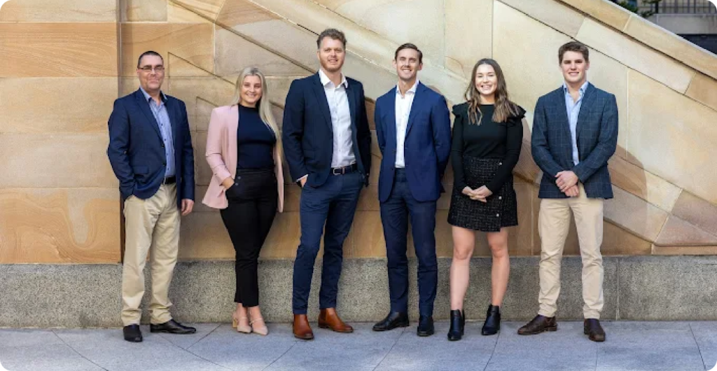 The Barrack Broking team of insurance brokers standing outside a Sydney sandstone building