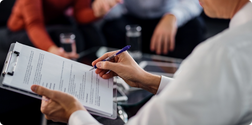 Broker going through a lease agreement with clients during a meeting
